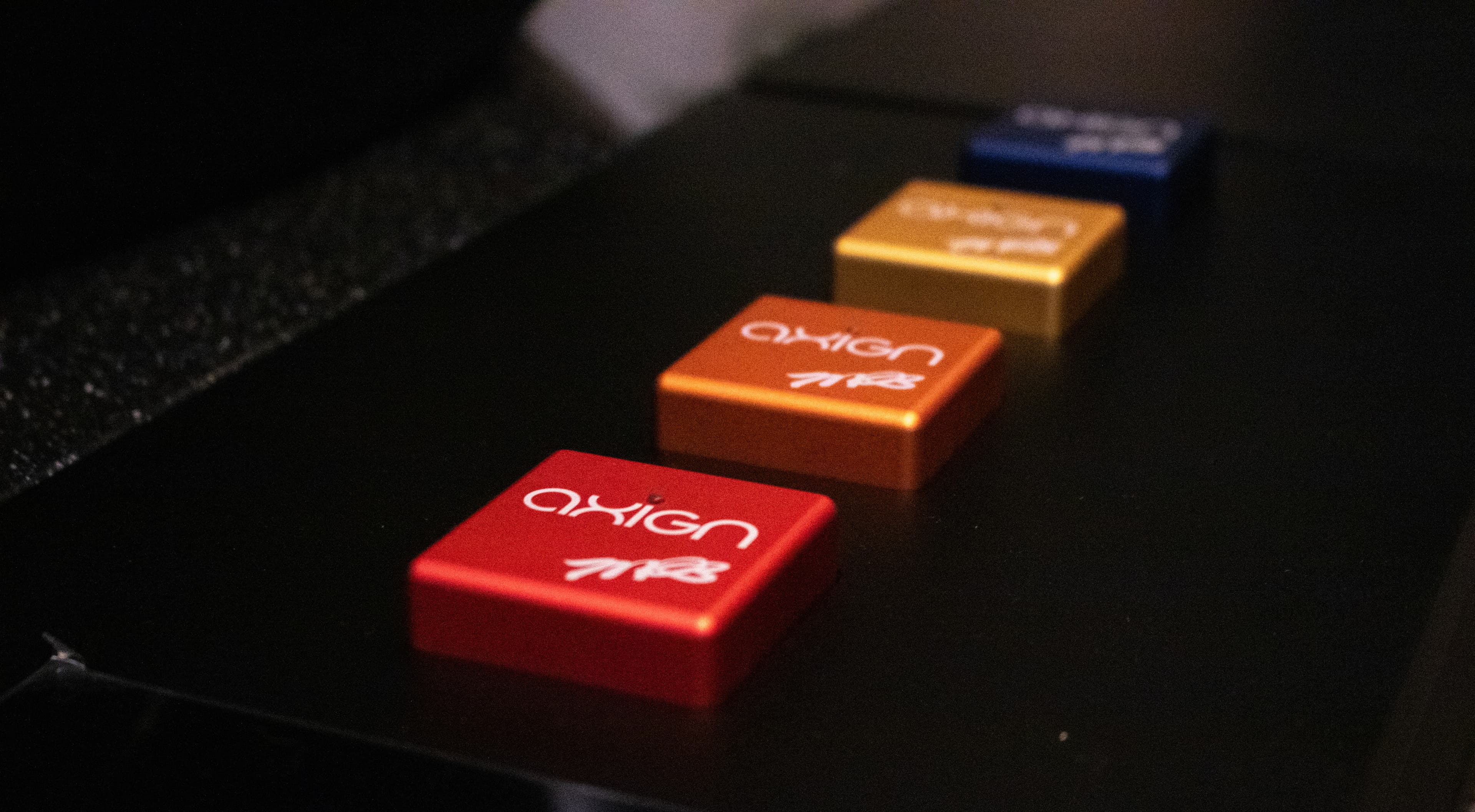 Axign amplifier module controls in red, orange, and gold